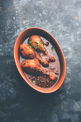 Chicken leg / drumstick curry or Murg Tangri/tangdi masala. Served in a bowl over moody background. Selective focus