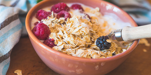 Smoothie yogurt bowl with oats and berries on wooden rustic board. Healthy eating breakfast