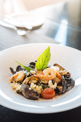 Black fettuccine with shrimp, squid and clam. Seafood squid ink pasta.