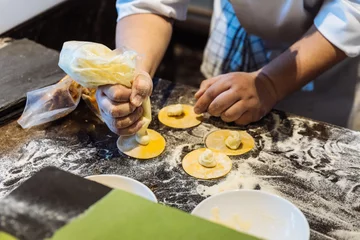 Foto op Canvas Chef making circle shape Ravioli by filling sage and butter on pasta dough. © artitwpd