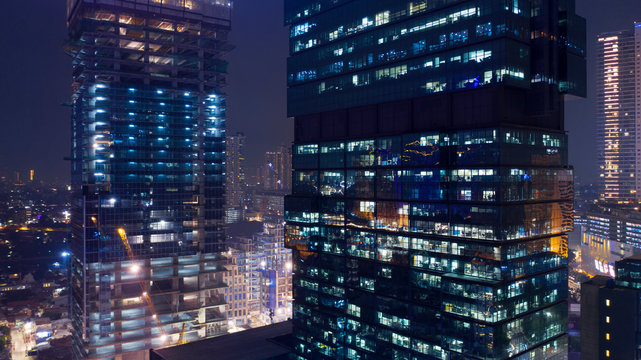 Two skyscrapers with glowing light at night