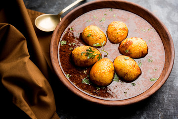 Fried egg curry or anda masala served in a bowl. selective focus