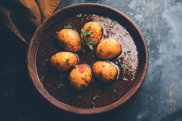 Fried egg curry or anda masala served in a bowl. selective focus