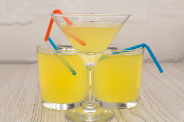 Ice tea with ice, lemon and mint on a combined colored yellow background Summer cold drink cocktail. Copyspace