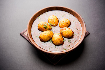 Fried egg curry or anda masala served in a bowl. selective focus