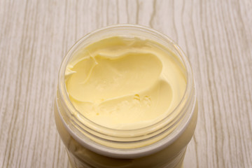 Mayonnaise in round dish isolated on white background, top view .