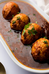 Fried egg curry or anda masala served in a bowl. selective focus