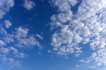 amazing white clouds of unusual shape on blue sky background .