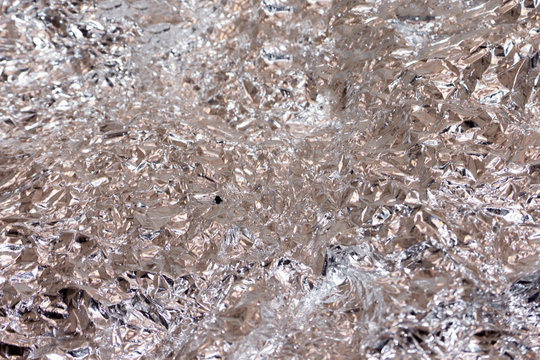 Background texture of crumpled aluminum foil color,