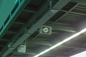 Old loudspeakers under the roof of the railway station