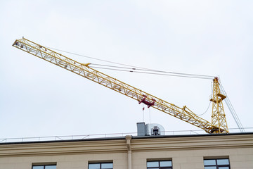 Upper part of the construction crane above the building