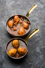 anda/egg curry with tangri/tangdi chicken masala. served in a serving pan. selective focus