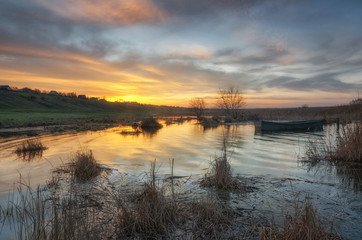 Fototapeta na wymiar Coast of the spring river with sunrise view