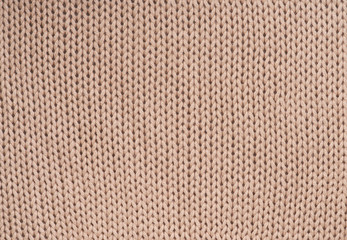 Creamy wool knitted background close-up.Texture of beige  knit blanket. Plaid merino wool. Top view