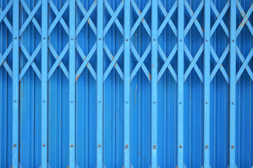 Steel folding sliding door retro texture background / stainless steel old door blue background