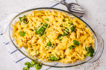 Casserole with pasta, chicken, broccoli and cheese crust in a glass form, top view.