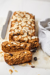 Vegan carrot bread with almonds on a white background.