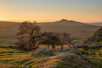 Stunning landscape sunset image over abandoned Foggintor Quarry in Dartmoor with raking soft...