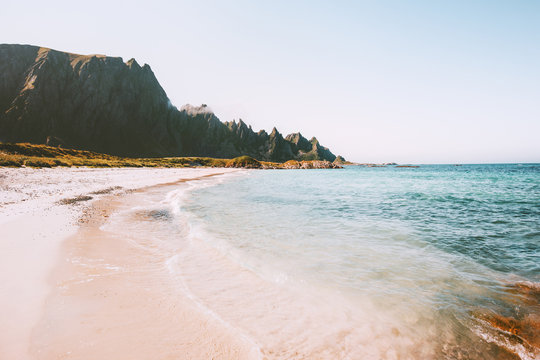 Sea beach landscape in Norway idyllic empty sandy coast view summer travel vacations nature scenery seaside and mountains rocks