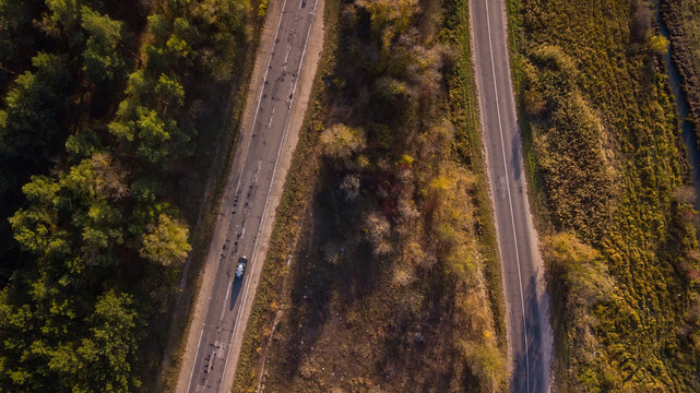 Aerial view of the road through fall forest © Igor Syrbu