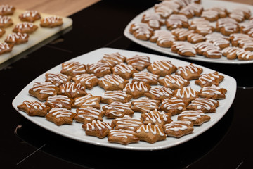 Gingerbread lebkuchen stars white sugar decorated on plate