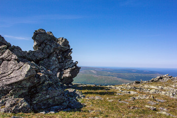Huge boulders on the plateau. Wildlife of the Northern Urals. Beautiful panoramic view of the ridges and valleys.