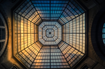 Glass and iron patterned ceiling roof of huge dome view from below