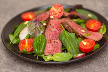 Roast Beef Salad with Green Mix. Thick Slices of Juicy Medium Rare Veal. Delicious gourmet beef salad