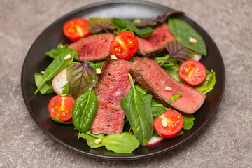 Roast Beef Salad with Green Mix. Thick Slices of Juicy Medium Rare Veal. Delicious gourmet beef salad