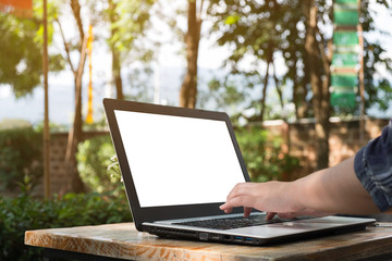 Obraz premium Woman used laptop on wooden table, business working, mock up on display
