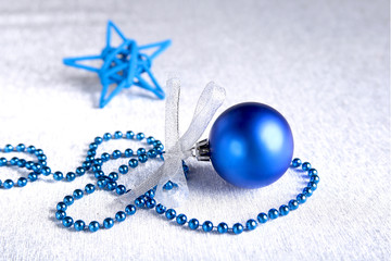 Christmas or holiday composition with blue silver balls on billowy feathers with snow and snowflakes.