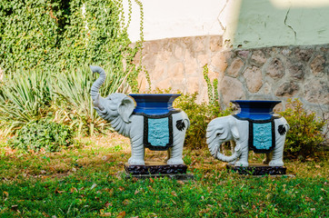 Sculptures of elephants in autumn yard