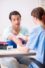 Young patient during blood test sampling procedure  