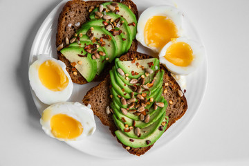 spicy rye toast with avocado and egg, top view