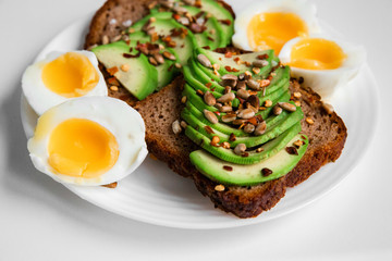 Fresh avocado with egg on baguette pieces, photographed overhead with natural light