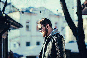 portrait of a handsome man dressed in leather jacket and jeans