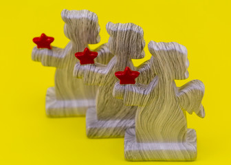 figures of angels with hearts on a yellow background. decorate the house