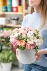 floral bunch in head box. European floral shop. Bouquet of beautiful Mixed flowers in woman hand. Excellent garden flowers in the arrangement , the work of a professional florist.