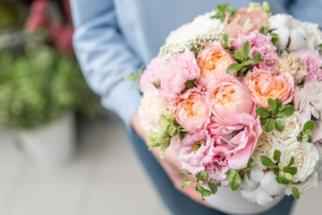 floral bunch in head box. European floral shop. Bouquet of beautiful Mixed flowers in woman hand. Excellent garden flowers in the arrangement , the work of a professional florist.