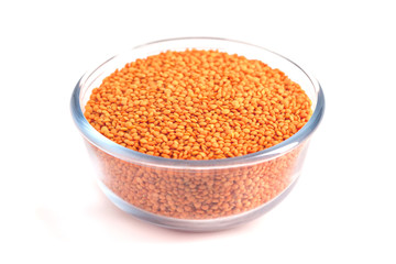 Yellow lentil in glass bowl isolated on white background