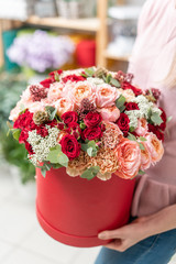 floral bunch in head box. European floral shop. Bouquet of beautiful Mixed flowers in woman hand. Excellent garden flowers in the arrangement , the work of a professional florist.