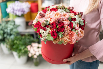 floral bunch in head box. European floral shop. Bouquet of beautiful Mixed flowers in woman hand. Excellent garden flowers in the arrangement , the work of a professional florist.