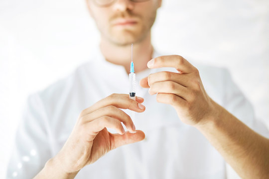injection to induce anesthesia , close up cropped photo. maomebodn is going to give sy a needle. safety and efficacy of the vaccine