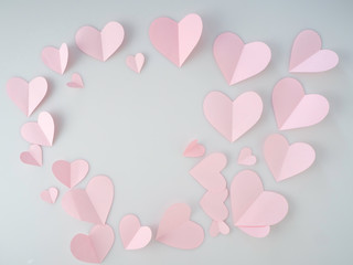 Pink paper hearts placed on white background.