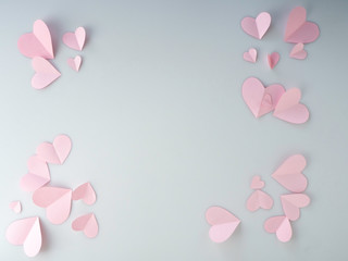 Pink paper hearts placed on white background.