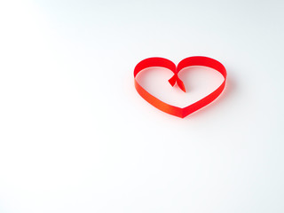 Red ribbon heart-shaped on a white background.