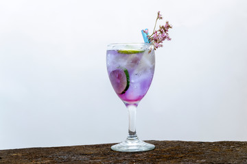 refreshing purple cocktail in wine glass