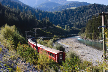 Swiss mountain train Bernina Express drives through Rheinschlucht, Switzerland