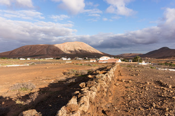 Landscape with cloudy sky in the region of La Oliva. Fuerteventura, Canary Islands, Spain