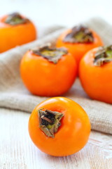 Ripe persimmon fruit on wooden table ready for eat